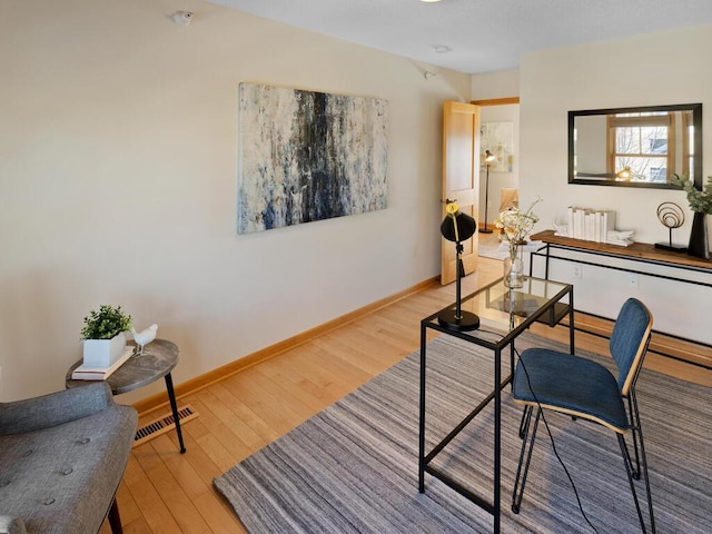 office space featuring radiator heating unit and light hardwood / wood-style flooring