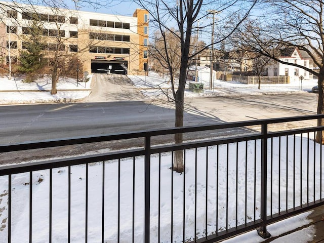 view of snow covered back of property