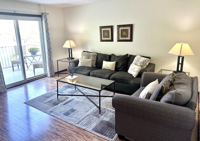 living room featuring a textured ceiling and hardwood / wood-style flooring