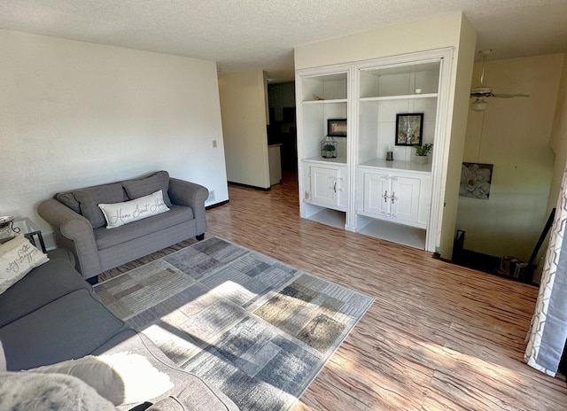 living room with a textured ceiling and hardwood / wood-style flooring