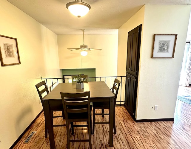 dining space featuring light hardwood / wood-style flooring and ceiling fan