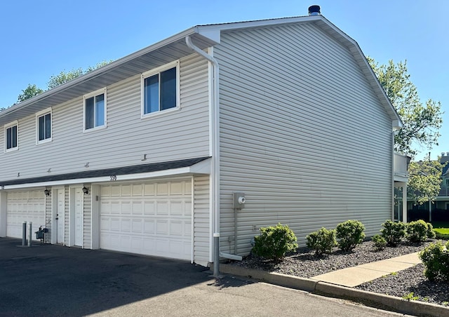 view of side of home featuring a garage