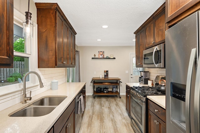 3706 90th St, Bloomington, MN 55431 - kitchen featuring stainless steel appliances, backsplash, light wood finished floors, recessed lighting, and pendant lighting