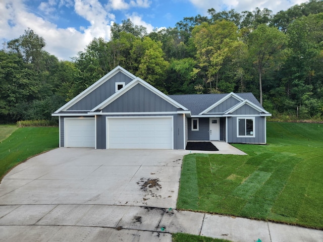 view of front of house with a front yard and a garage