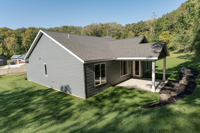 back of house with a yard and a patio area