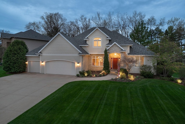 view of front of house featuring a garage and a yard