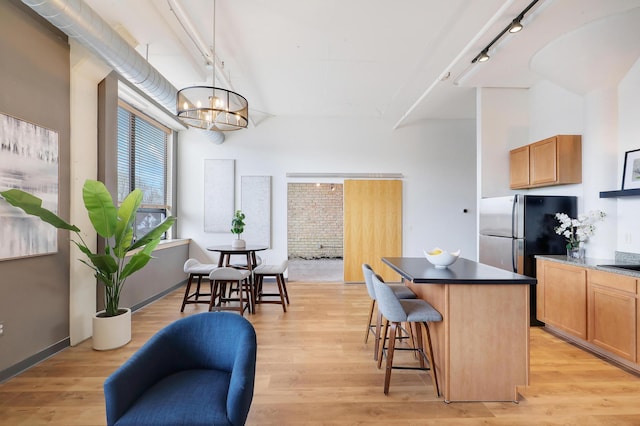 kitchen featuring light wood-type flooring, pendant lighting, and a center island