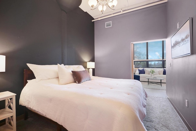 carpeted bedroom with an inviting chandelier