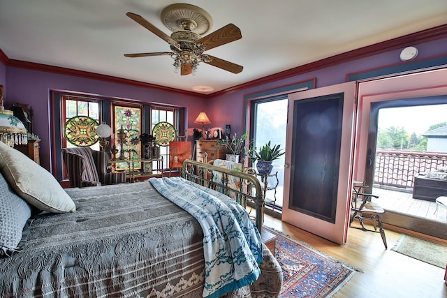 bedroom with multiple windows, crown molding, access to outside, and light hardwood / wood-style floors