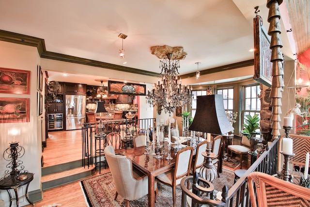 dining room featuring crown molding, a notable chandelier, and light hardwood / wood-style floors