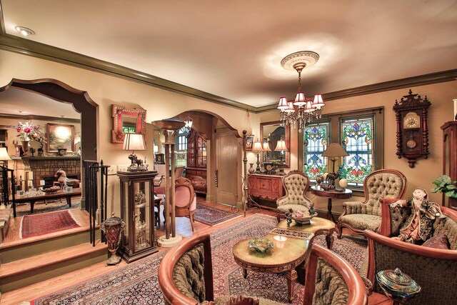 living room featuring hardwood / wood-style floors, crown molding, and a chandelier