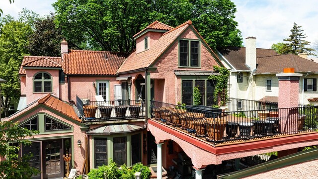 rear view of property featuring a balcony