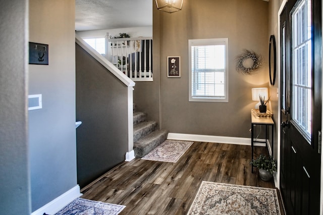 entrance foyer featuring dark hardwood / wood-style floors