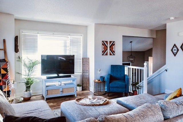 living room featuring a textured ceiling and hardwood / wood-style flooring