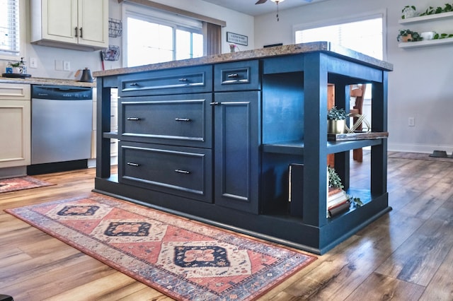 kitchen featuring dishwasher, hardwood / wood-style flooring, white cabinetry, and blue cabinetry