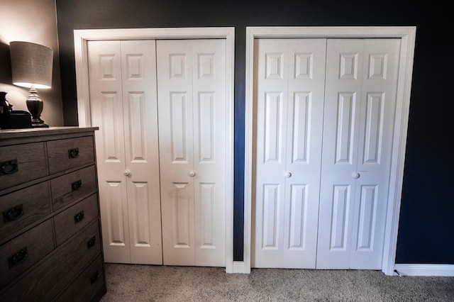 carpeted bedroom featuring multiple closets