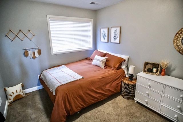 bedroom featuring dark carpet