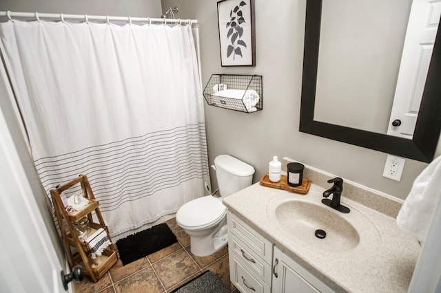 bathroom with vanity, curtained shower, and toilet