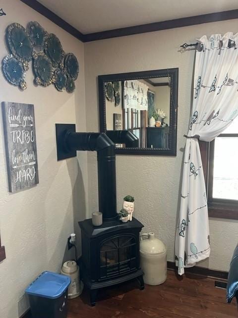 room details with a wood stove and wood-type flooring