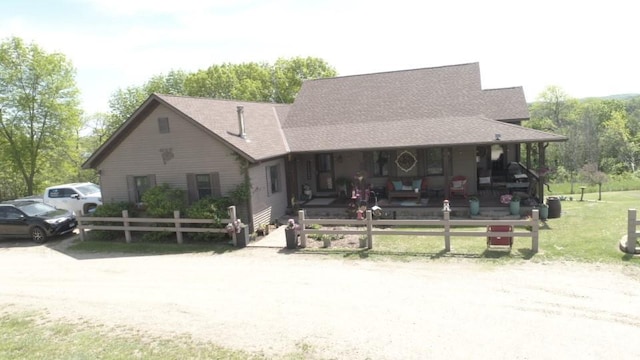 view of front of property with covered porch and a front yard