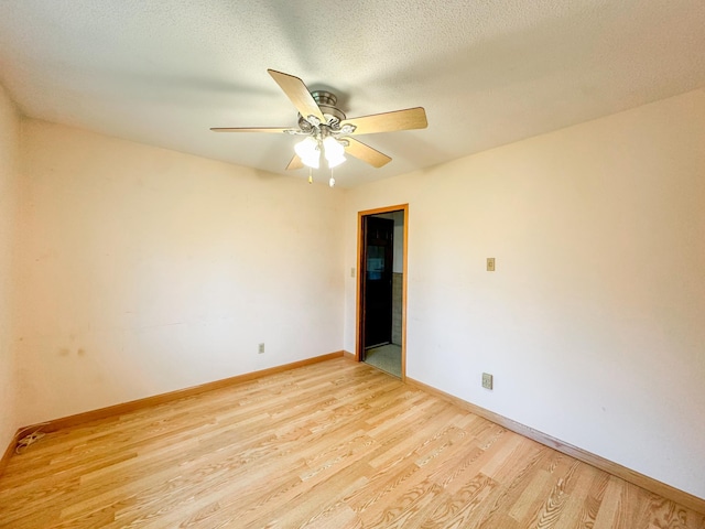 unfurnished room featuring light hardwood / wood-style floors, a textured ceiling, and ceiling fan