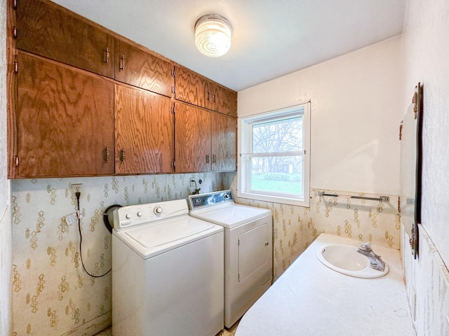 laundry area with cabinets, sink, and washing machine and dryer