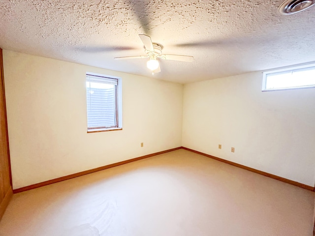 unfurnished room featuring ceiling fan and a textured ceiling