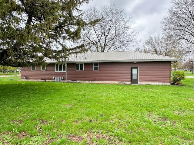 rear view of house featuring a yard and cooling unit