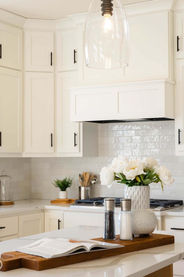 kitchen with decorative backsplash and white cabinetry