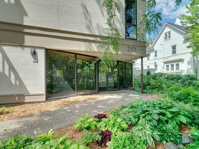 view of exterior entry featuring a carport