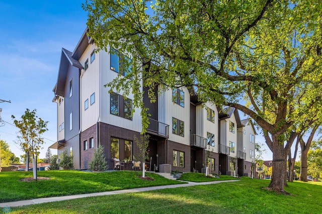 view of building exterior featuring central AC unit and a residential view