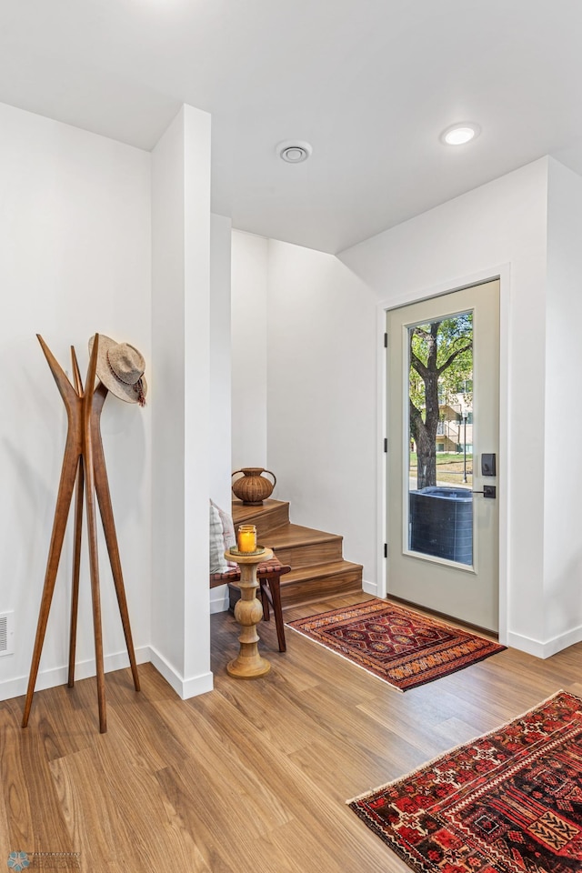 foyer with recessed lighting, baseboards, and wood finished floors