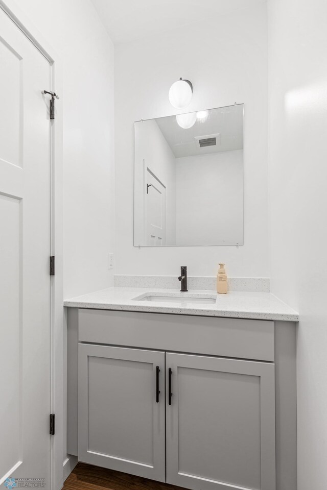 bathroom with hardwood / wood-style floors and vanity