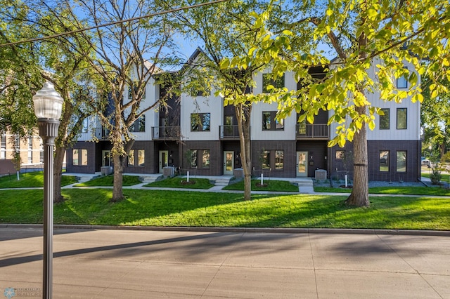 multi unit property with central air condition unit and a front yard