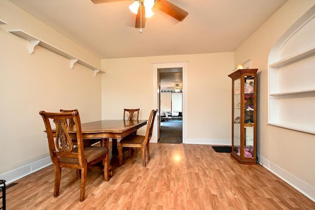 dining area with ceiling fan and light hardwood / wood-style flooring