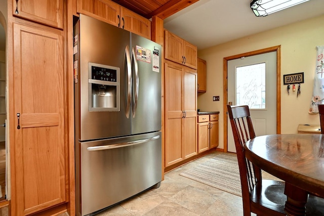 kitchen with beamed ceiling and stainless steel fridge with ice dispenser