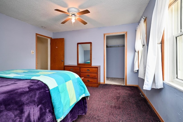 carpeted bedroom featuring ceiling fan, a textured ceiling, and a closet