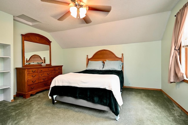 bedroom featuring vaulted ceiling, ceiling fan, carpet floors, and a textured ceiling