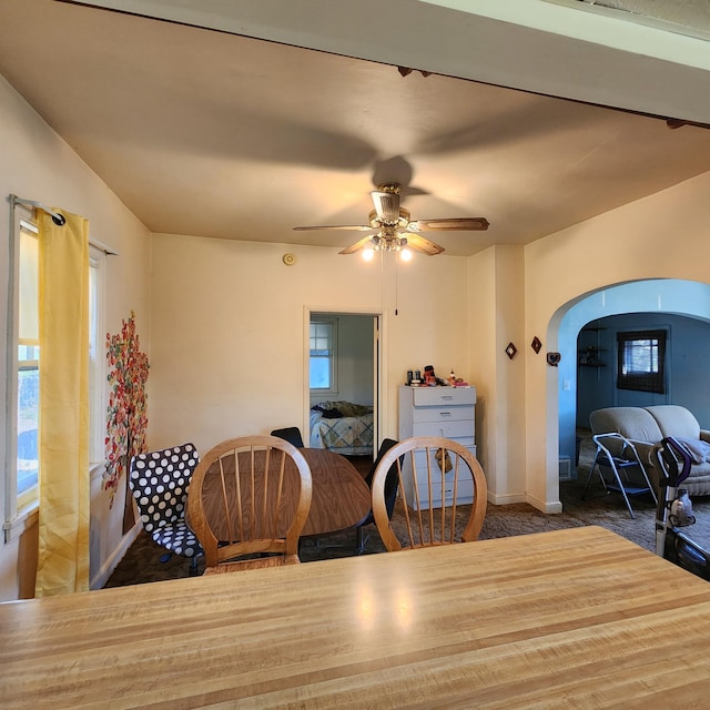 dining area with ceiling fan and carpet floors