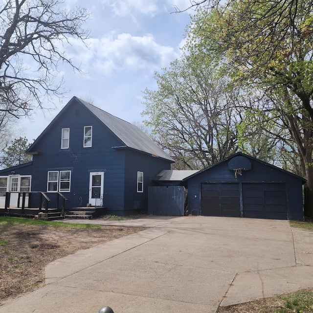 exterior space featuring a garage and an outdoor structure