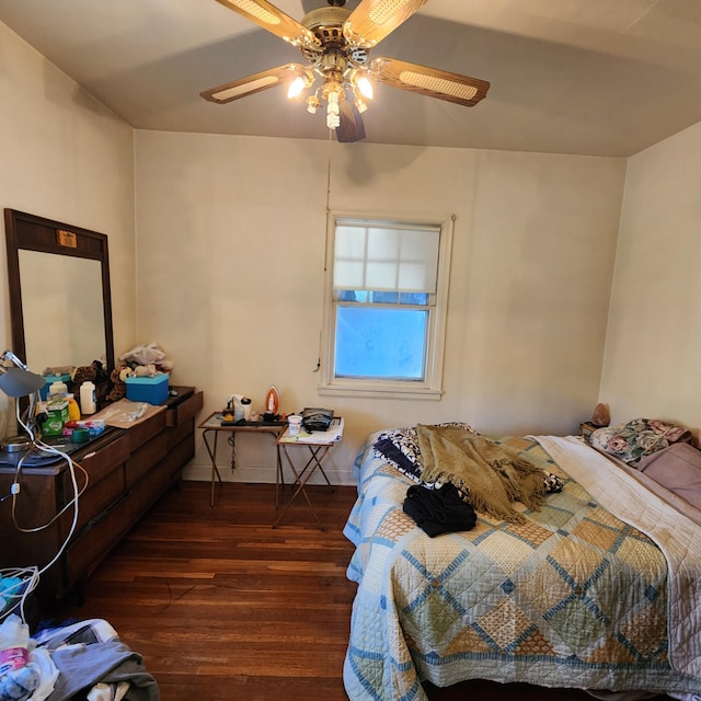 bedroom featuring ceiling fan and dark wood-type flooring