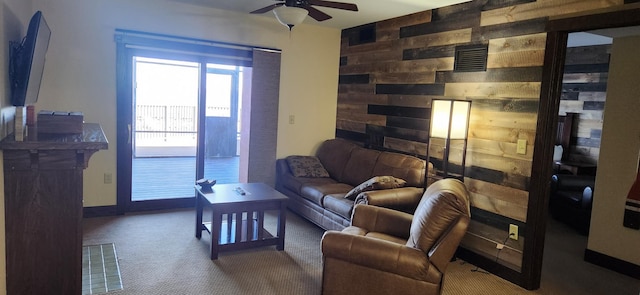 carpeted living room featuring a wealth of natural light and ceiling fan