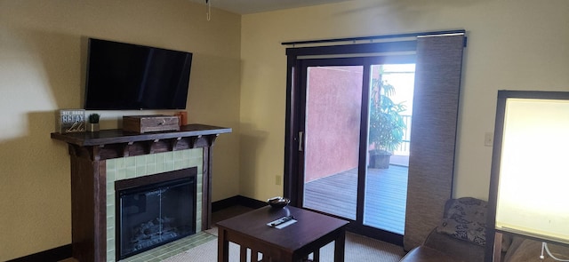 living room with a tile fireplace