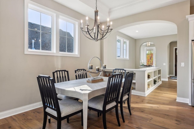 dining area with crown molding, hardwood / wood-style flooring, and a wealth of natural light