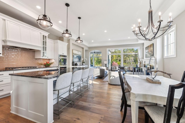 dining area featuring sink, crown molding, and dark hardwood / wood-style flooring