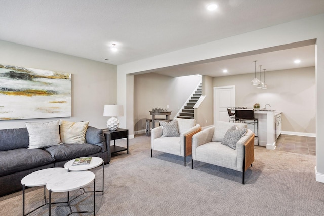 living room featuring sink and light carpet