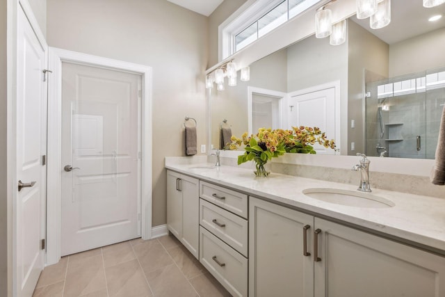 bathroom featuring walk in shower, vanity, and tile patterned flooring