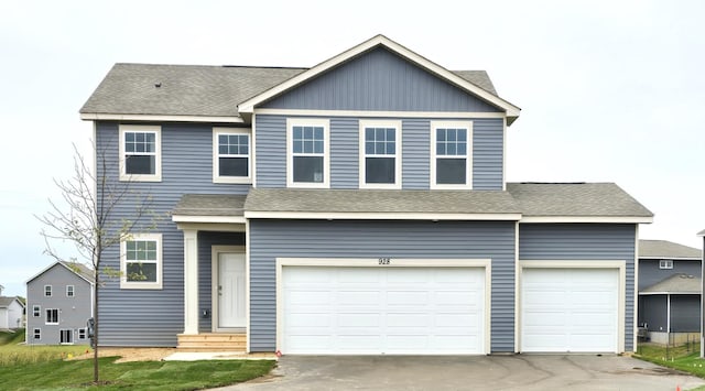 view of front of property featuring central AC unit and a garage