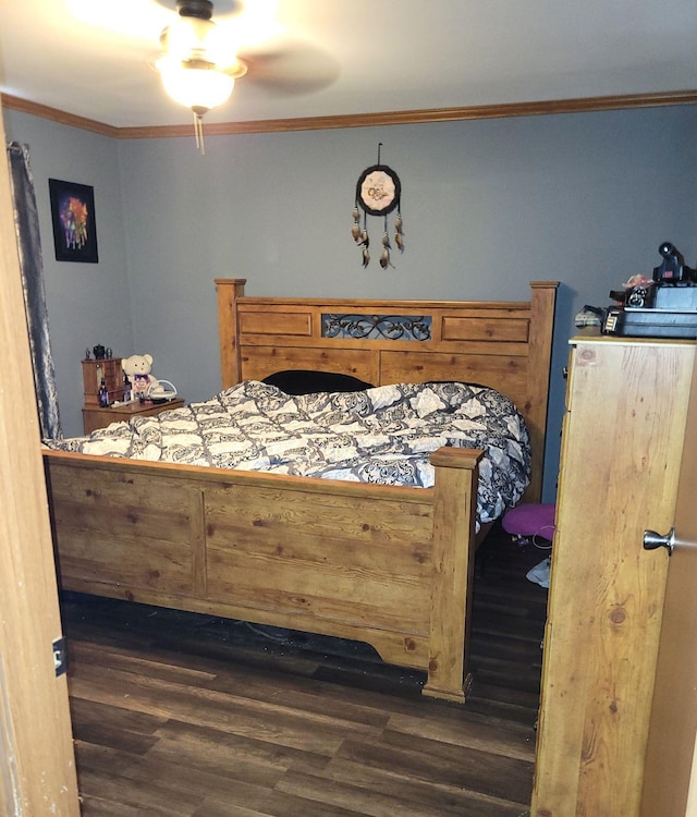 bedroom with ornamental molding and dark hardwood / wood-style flooring