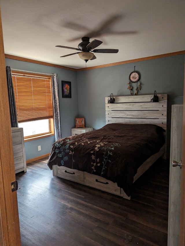 bedroom featuring crown molding, dark wood-type flooring, and ceiling fan